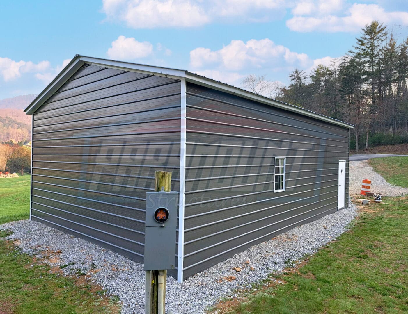 A metal garage with a door and window.