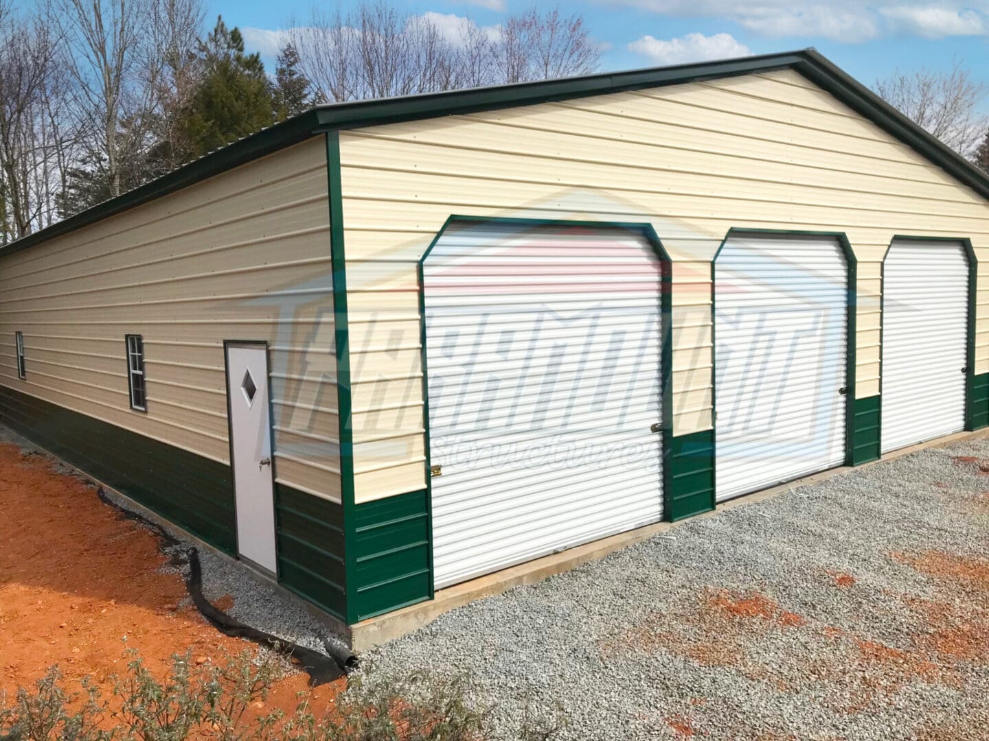 A garage with two doors and a door that has been painted green.