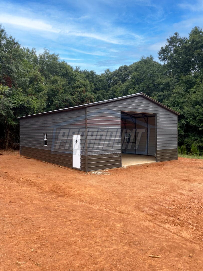 A metal garage with a door open on the side.