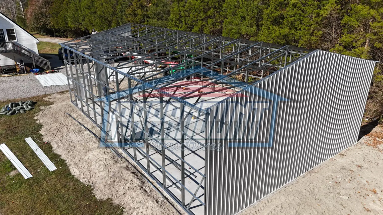 An aerial view of a metal building with a roof.