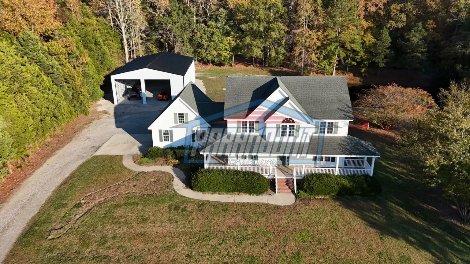 An aerial view of a home in the woods.