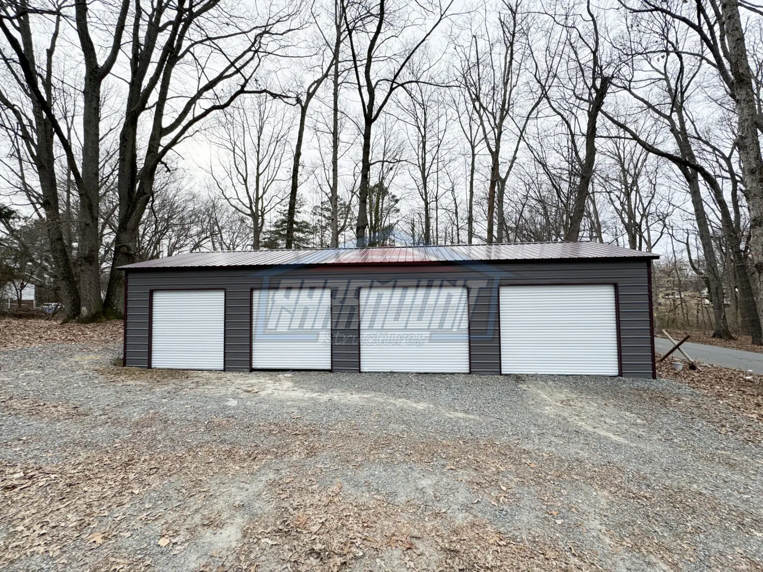 A metal building with three garage doors.