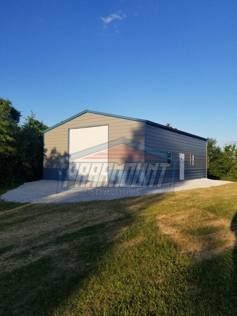 Gray and blue metal garage with a door.