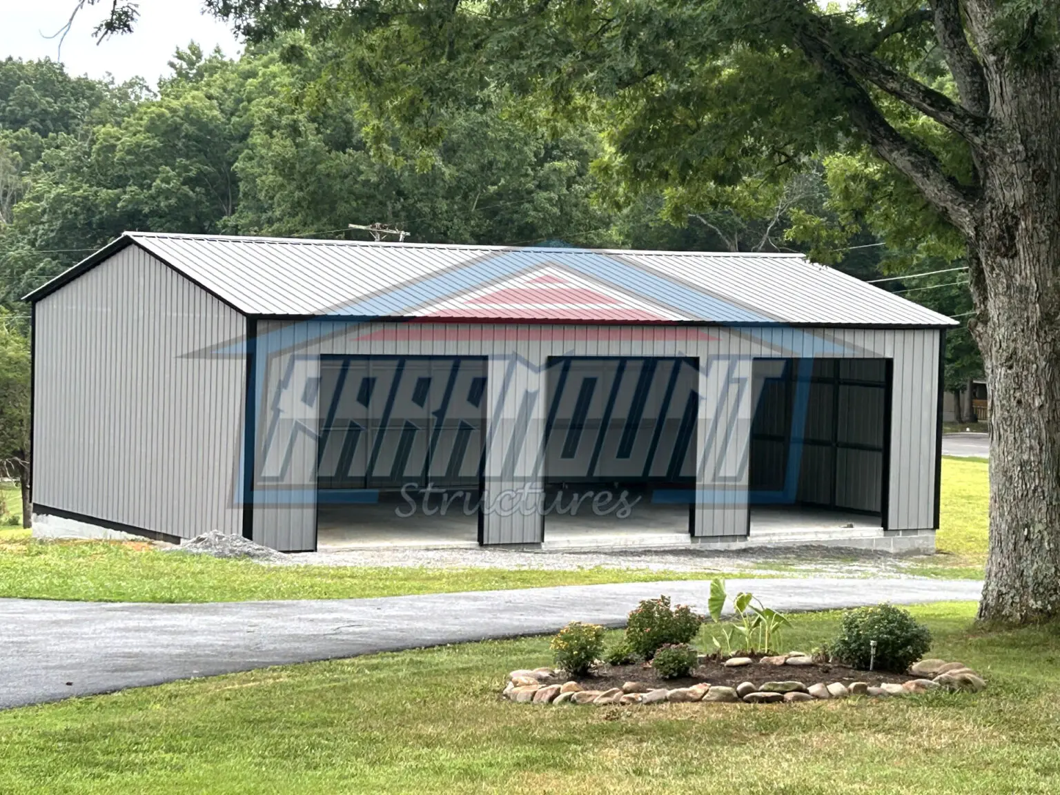 Gray metal garage with three doors.